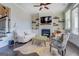 Inviting living room with a fireplace, hardwood floors, comfortable seating, and a ceiling fan at 1461 Thomas St, Conyers, GA 30094
