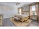 Luxurious main bedroom featuring dark wood floors, decorative rug, and white paneled walls with natural lighting at 1461 Thomas St, Conyers, GA 30094