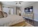 Bright main bedroom features hardwood floors, barn door to bathroom, and large dresser with TV at 1461 Thomas St, Conyers, GA 30094
