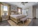 Well-lit main bedroom featuring dark hardwood floors, a decorative rug, an ensuite bath, and lots of pillows at 1461 Thomas St, Conyers, GA 30094