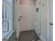 Modern glass shower with white tiled walls, grid floors, seating, and stainless steel hardware at 1461 Thomas St, Conyers, GA 30094
