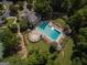 Aerial view showcasing a large community pool with ample seating, surrounded by mature trees and landscaping at 240 Trotters Rdg, Fayetteville, GA 30215