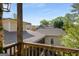 Backyard view from an outdoor porch with wooden railings and string lights at 240 Trotters Rdg, Fayetteville, GA 30215