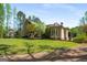 Expansive backyard featuring lush lawn and mature trees, perfect for outdoor activities and entertaining at 240 Trotters Rdg, Fayetteville, GA 30215