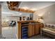Basement bar area with wooden cabinets, a mini fridge, and a view to the living space at 240 Trotters Rdg, Fayetteville, GA 30215