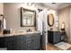 Dual-sink bathroom with granite countertops, ornate mirrors, and decorative fixtures and trim at 240 Trotters Rdg, Fayetteville, GA 30215