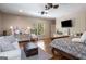 Bright bedroom features hardwood floors, ceiling fan, and built-in storage beneath a wall-mounted television at 240 Trotters Rdg, Fayetteville, GA 30215