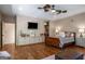 Spacious bedroom featuring hard wood floors, a flat-screen TV, and a decorative ceiling fan at 240 Trotters Rdg, Fayetteville, GA 30215