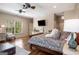 Spacious bedroom with a ceiling fan, window view, and decorative floral bedspread at 240 Trotters Rdg, Fayetteville, GA 30215