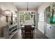 Bright dining room with brick flooring, natural light, and a rustic wood table at 240 Trotters Rdg, Fayetteville, GA 30215