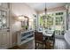 Sunny dining room with a rustic table, chandelier lighting, and large windows at 240 Trotters Rdg, Fayetteville, GA 30215