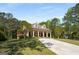 Beautiful traditional home with a sprawling lawn, mature trees, circular drive, and a large covered front porch at 240 Trotters Rdg, Fayetteville, GA 30215