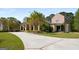 Traditional home with a large circular drive, mature trees, manicured lawn and a covered front porch with columns at 240 Trotters Rdg, Fayetteville, GA 30215