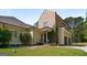 Charming exterior featuring a brick and siding facade, a covered porch, and a well-manicured lawn at 240 Trotters Rdg, Fayetteville, GA 30215