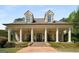 Stately home featuring columns, dormer windows, a symmetrical facade and a welcoming brick walkway and expansive porch at 240 Trotters Rdg, Fayetteville, GA 30215