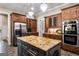 A large island is the focal point of this spacious kitchen with stainless appliances and custom cabinetry at 240 Trotters Rdg, Fayetteville, GA 30215
