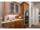 The kitchen features a wet bar with decorative wood cabinets and stainless steel appliances at 240 Trotters Rdg, Fayetteville, GA 30215