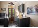 Lovely laundry room features granite countertops, custom cabinets, brick floors, and backyard access at 240 Trotters Rdg, Fayetteville, GA 30215
