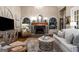 Bright living room with a decorative fireplace, built-in shelves, hardwood floors, and neutral walls at 240 Trotters Rdg, Fayetteville, GA 30215