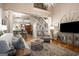 Open-concept living room with hardwood floors, a staircase with iron railings and a glimpse into the kitchen at 240 Trotters Rdg, Fayetteville, GA 30215