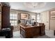 Office space featuring a large wooden desk, guitars, and a decorative chandelier at 240 Trotters Rdg, Fayetteville, GA 30215