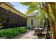 Inviting outdoor patio with brick flooring, a screened-in porch, and charming backyard landscaping at 240 Trotters Rdg, Fayetteville, GA 30215