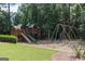 Community playground featuring a playset with slide and swing set in wooded area at 240 Trotters Rdg, Fayetteville, GA 30215