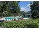 Community pool with lounge chairs and a clubhouse, all surrounded by lush greenery at 240 Trotters Rdg, Fayetteville, GA 30215