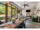 Screened in porch featuring a large wooden table, seating and an outdoor kitchen at 240 Trotters Rdg, Fayetteville, GA 30215