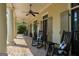 Inviting covered porch with rocking chairs, ceiling fans, beautiful double doors, and a brick floor at 240 Trotters Rdg, Fayetteville, GA 30215