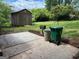 Backyard featuring a wooden shed, patio, green space, and trash cans at 2980 Catalina Dr, Decatur, GA 30032