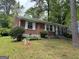 Exterior side view of a brick home with a well-kept lawn and traditional design elements at 2980 Catalina Dr, Decatur, GA 30032