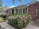 Charming brick home featuring a well-maintained yard with beautiful flowering shrubs at 2980 Catalina Dr, Decatur, GA 30032