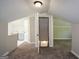 View of carpeted attic, featuring attic access, closet, and half bathroom area with sinks at 3164 Harris Dr, East Point, GA 30344