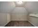 Finished attic space with beige walls, carpet, and a mini-split system for climate control at 3164 Harris Dr, East Point, GA 30344