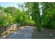 Backyard with a concrete patio area and wooden fence offers a secluded outdoor space surrounded by lush greenery at 3164 Harris Dr, East Point, GA 30344