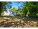 View of backyard and the back of the house with a wooden deck and stairs at 3164 Harris Dr, East Point, GA 30344