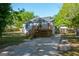 Backyard with a wooden deck and stairs leading down to a concrete pad at 3164 Harris Dr, East Point, GA 30344