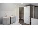 Bright bathroom featuring double sinks, gray cabinetry, and access to a walk-in closet at 3164 Harris Dr, East Point, GA 30344