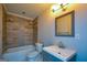 Well-lit bathroom with stylish tile, bathtub, vanity, and modern fixtures at 3164 Harris Dr, East Point, GA 30344