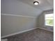 Cozy carpeted bedroom with neutral paint, white trim, and a window bringing in natural light at 3164 Harris Dr, East Point, GA 30344