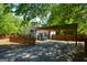 Charming home with wooden carport and fence, offering a blend of privacy and curb appeal at 3164 Harris Dr, East Point, GA 30344
