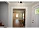 Inviting foyer with hardwood stairs, access to living room, fireplace, and hardwood flooring at 3164 Harris Dr, East Point, GA 30344