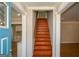 Inviting foyer with hardwood stairs, and open access to kitchen, and neutral colors at 3164 Harris Dr, East Point, GA 30344