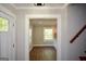 Inviting foyer with views to the dining area and hardwood flooring and neutral color palette at 3164 Harris Dr, East Point, GA 30344