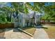 Charming home with mature trees, inviting blue door, and private driveway at 3164 Harris Dr, East Point, GA 30344