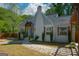Charming gray cottage with updated landscaping, wood accents and a blue front door at 3164 Harris Dr, East Point, GA 30344
