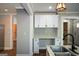 Open kitchen with granite countertops, stainless steel sink and appliances, and bright white cabinets at 3164 Harris Dr, East Point, GA 30344