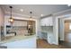 Spacious kitchen area featuring a large island, bright white cabinetry and modern lighting at 3164 Harris Dr, East Point, GA 30344