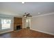 Bright living room with stone fireplace, ceiling fan, and hardwood floors at 3164 Harris Dr, East Point, GA 30344